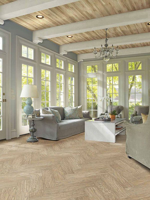 Light wood flooring in neutral contemporary sunroom  